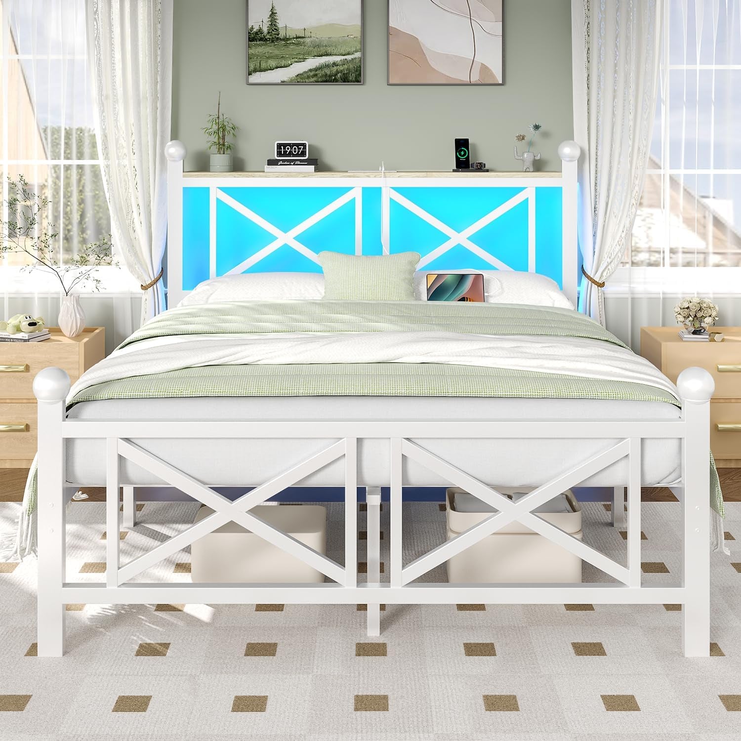 Front view of a white wooden bed with X‑style panels and glowing blue headboard in a bright bedroom.