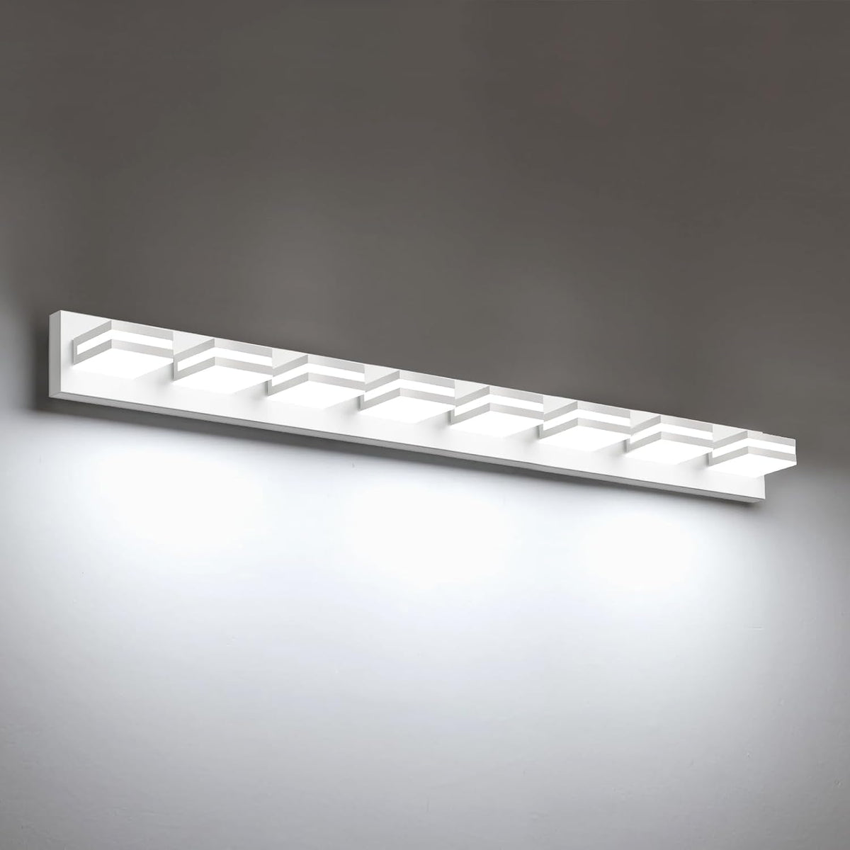 Angled view of a white LED vanity fixture showing eight recessed square light housings on a wall.