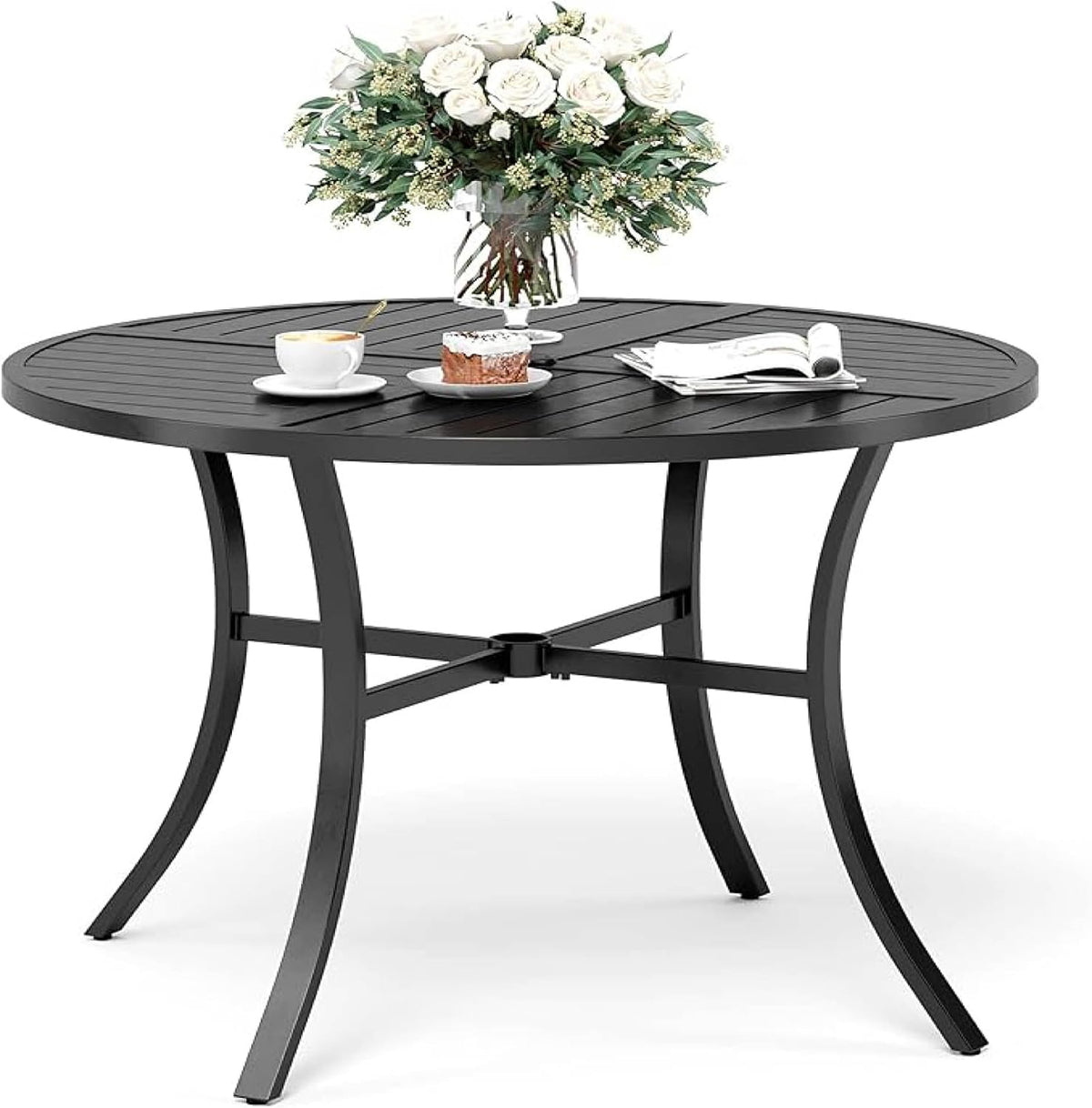 Round black metal patio table with slatted top, curved legs and an umbrella socket at the center, styled with a vase.
