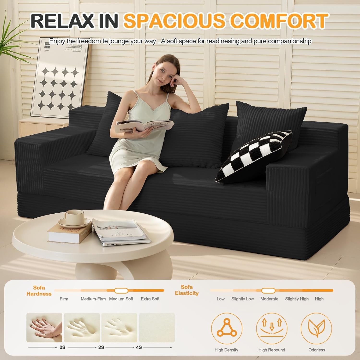 Model seated on the black corduroy sofa in a living room setting illustrating seat depth