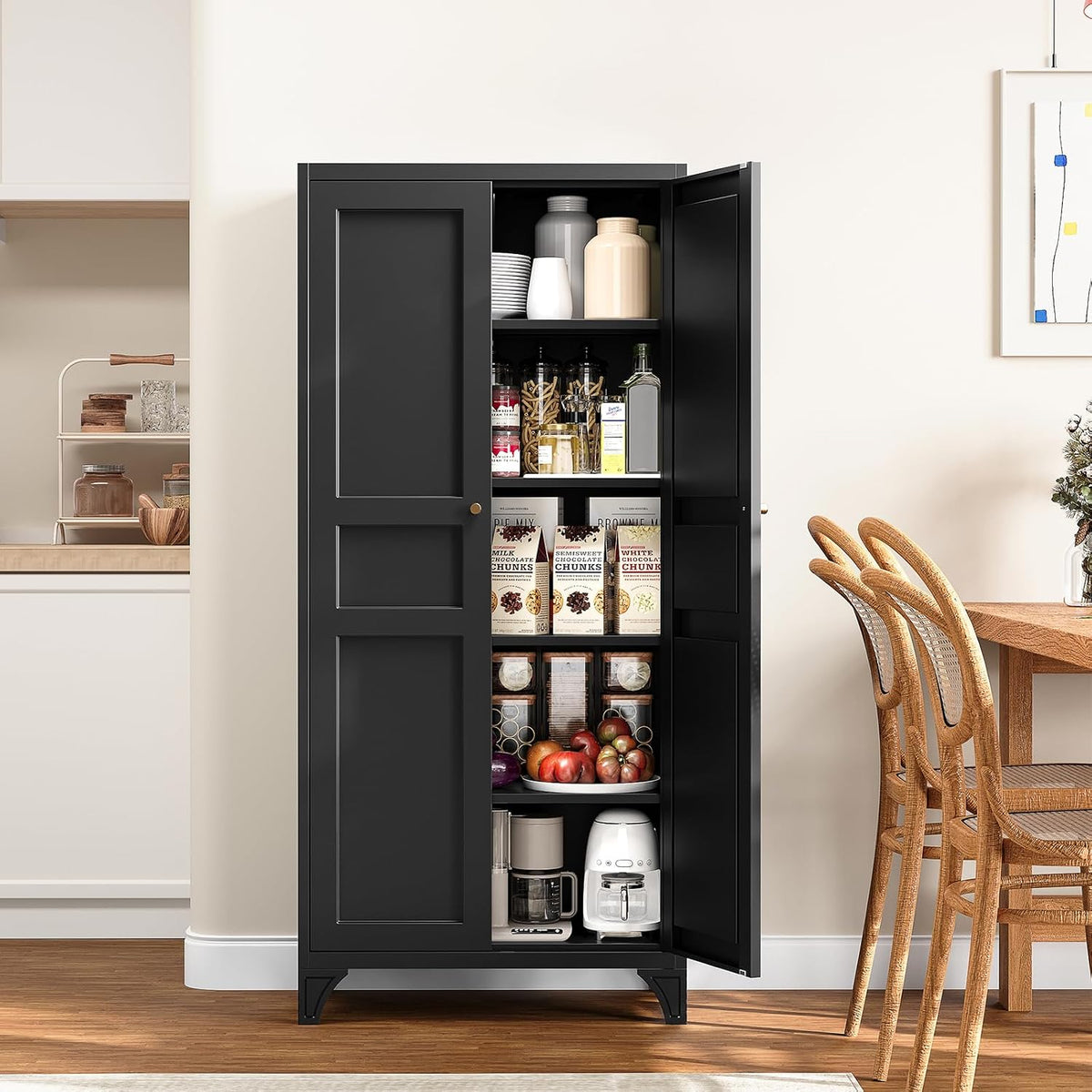 Black tall cabinet with one door open showing organized pantry items and appliances inside next to a dining table