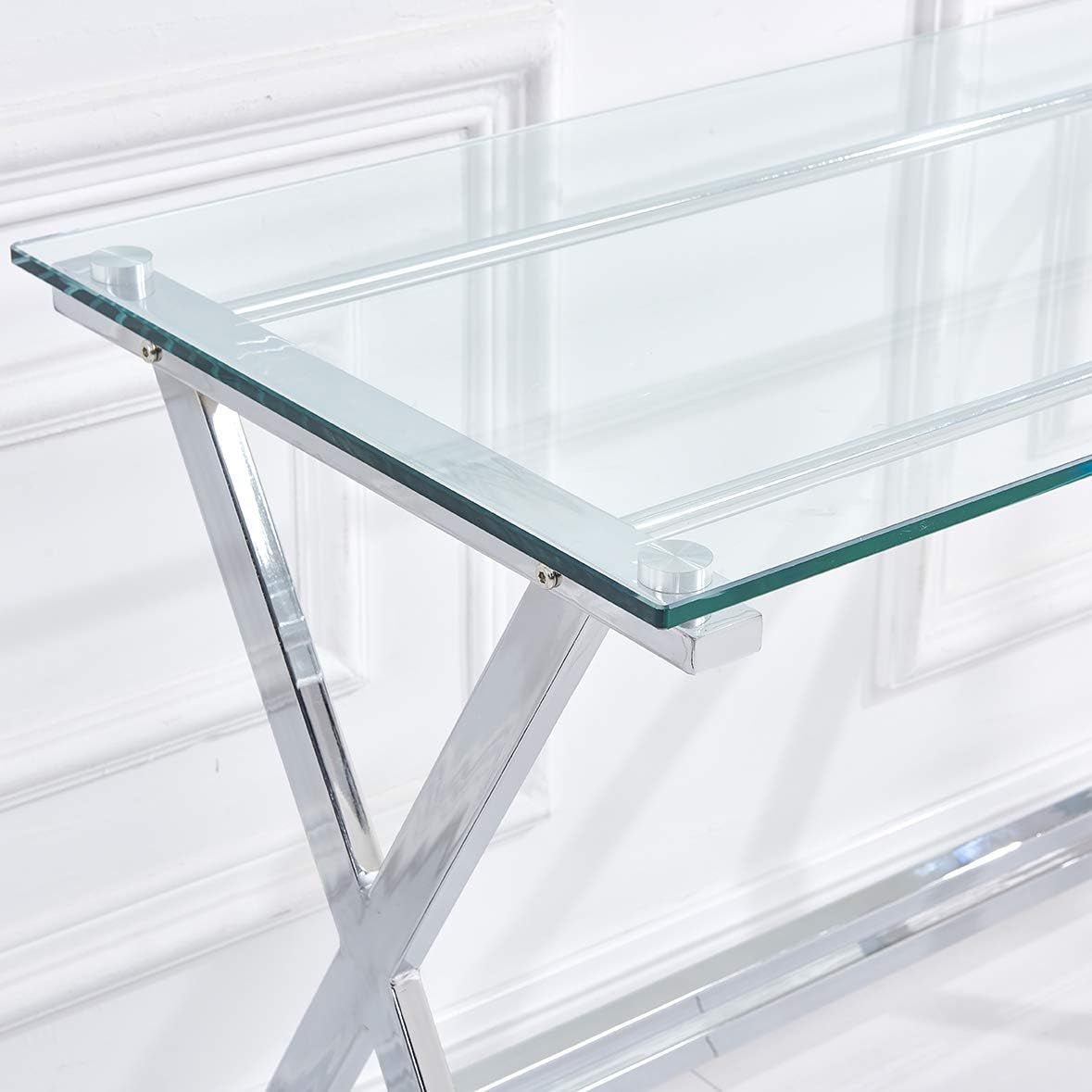 Close-up of thick glass top edge and round metal mounting cap over a polished X-shaped chrome leg.