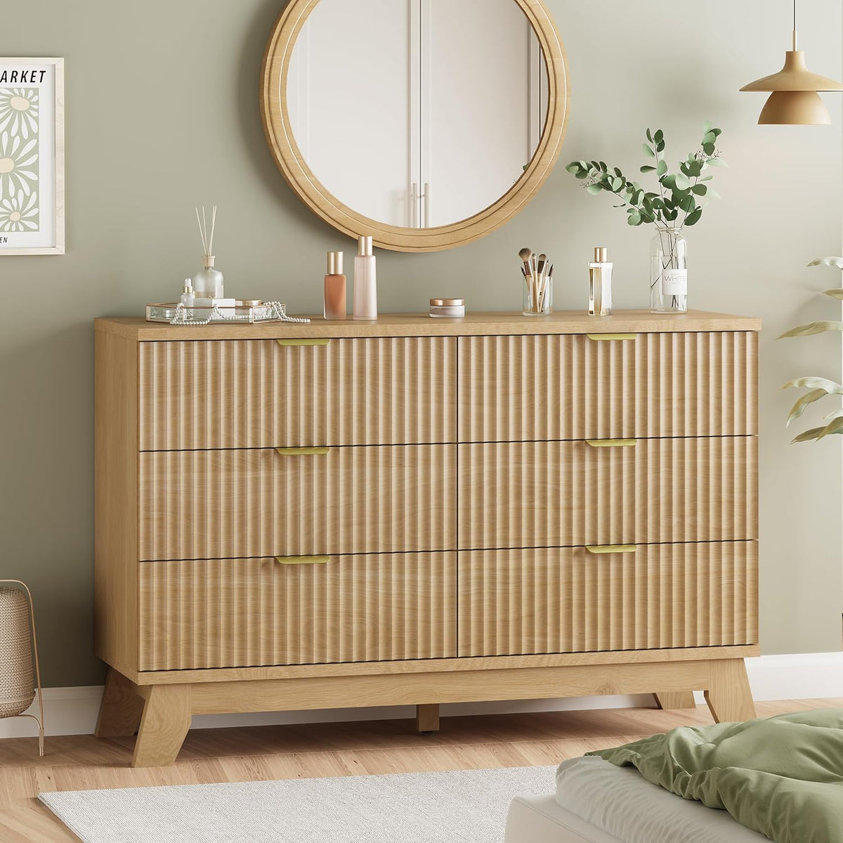 Wide natural wood dresser with fluted drawer fronts and gold handles, round wooden mirror above.