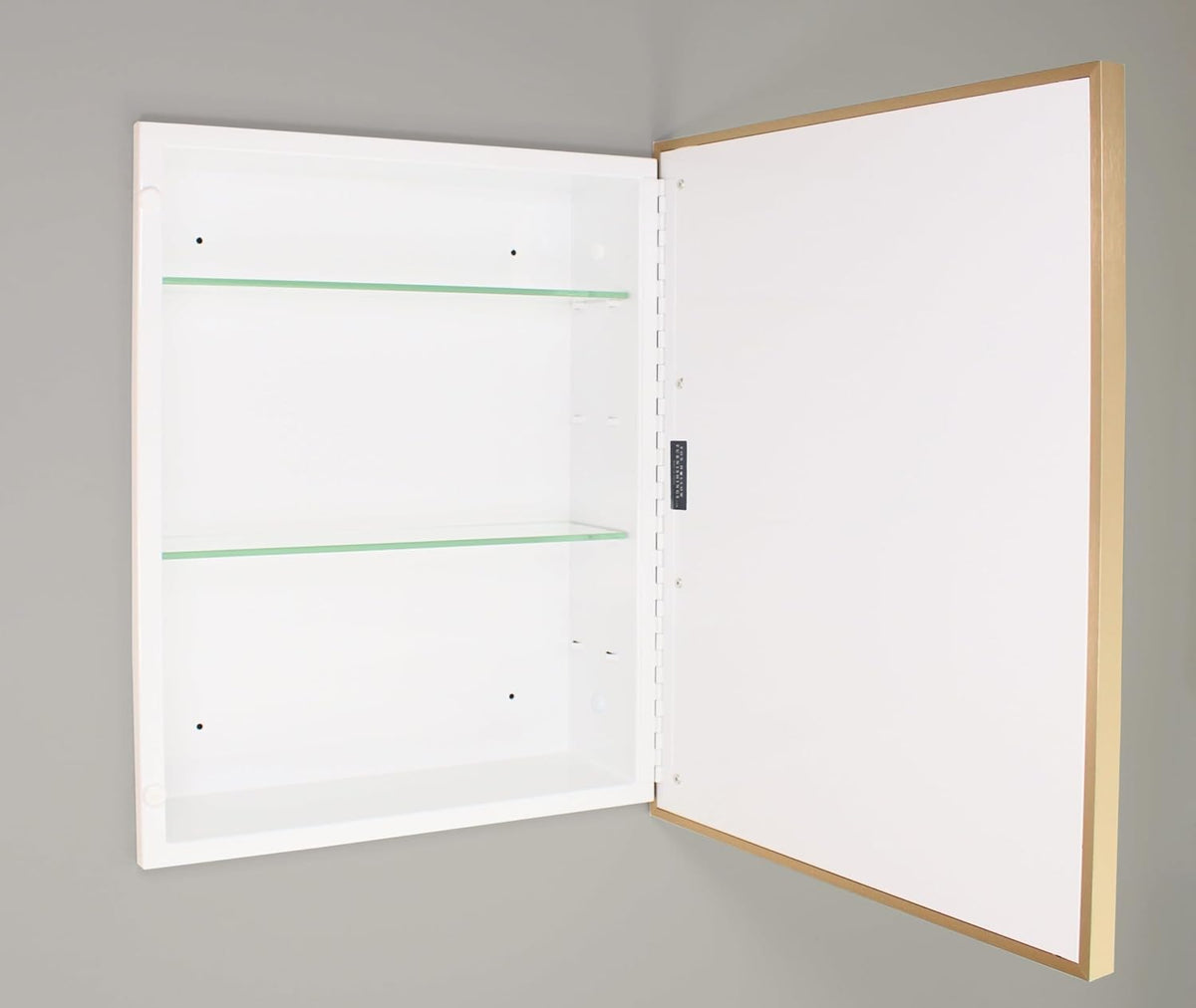 Open recessed cabinet interior showing two tempered glass shelves, white powder-coated steel interior and visible hinge area