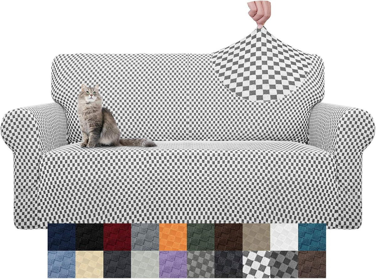 Front view of a two-seat sofa covered in a black-and-white checkered stretch slipcover with a cat on the seat.