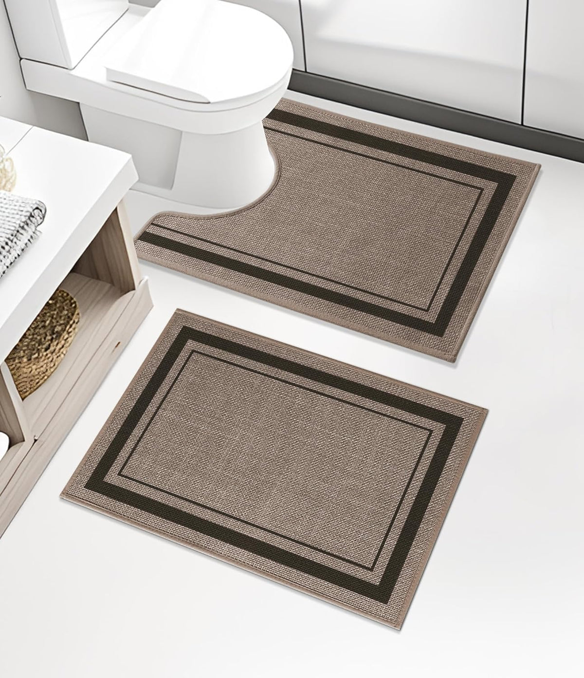 Two rectangular beige mats, one U-cut for toilet, placed on white bathroom floor