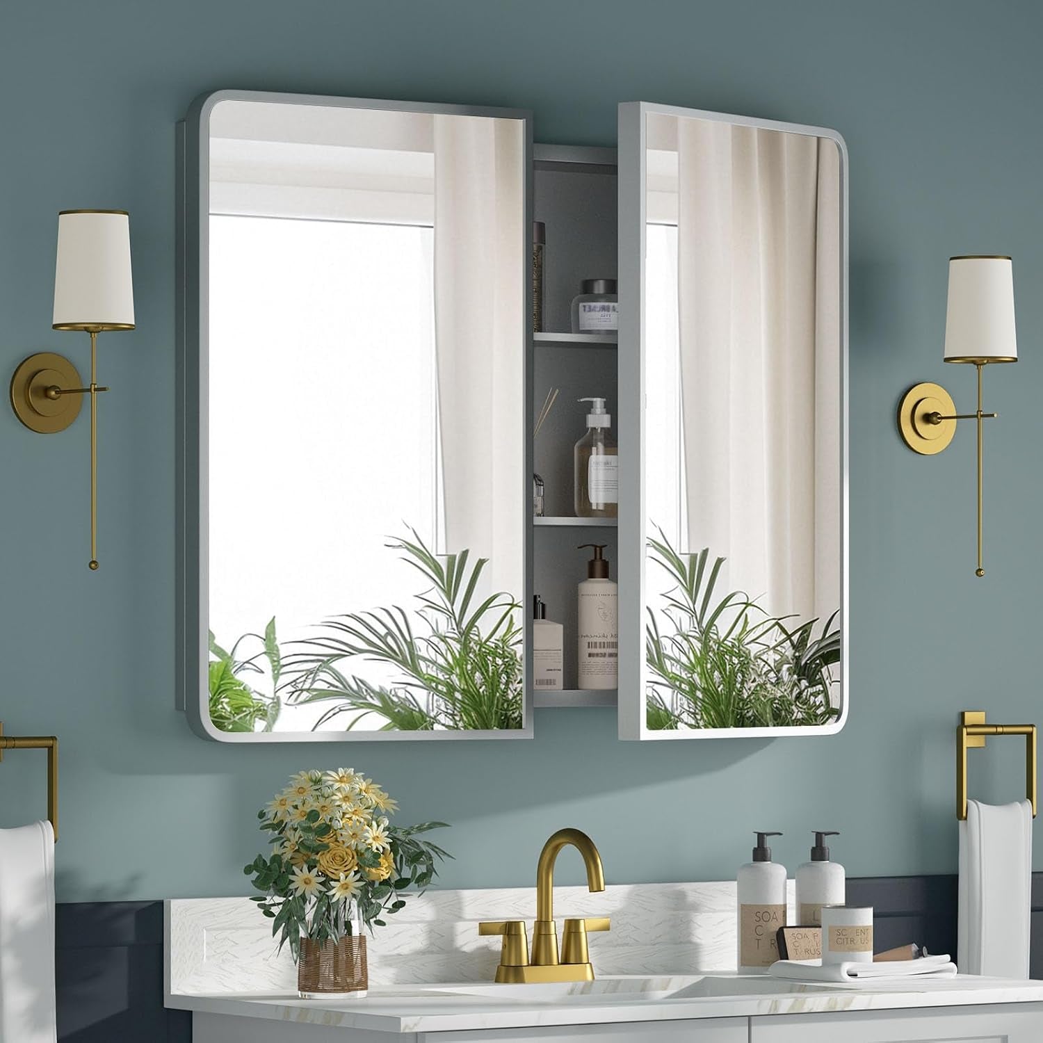 Double-door mirrored medicine cabinet in light gray with one door open revealing center shelves.