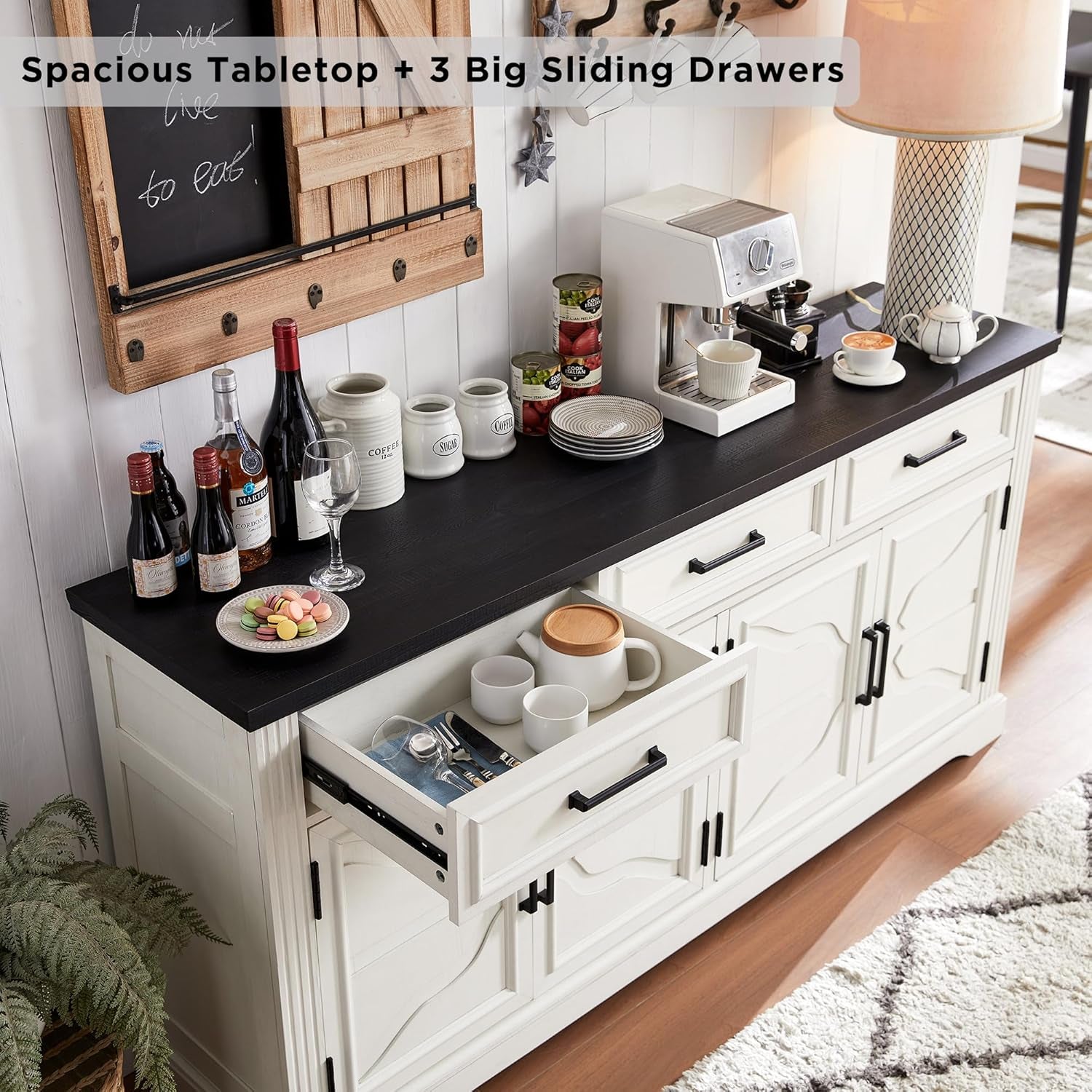 Angled top view of the sideboard with a sliding drawer open showing mugs and flatware on the interior