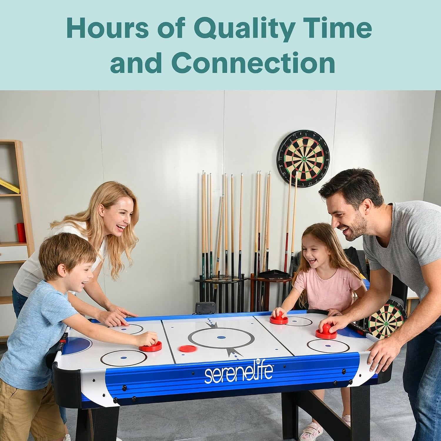 Wide room view of family playing at blue-trim air hockey table showing legs and play surface