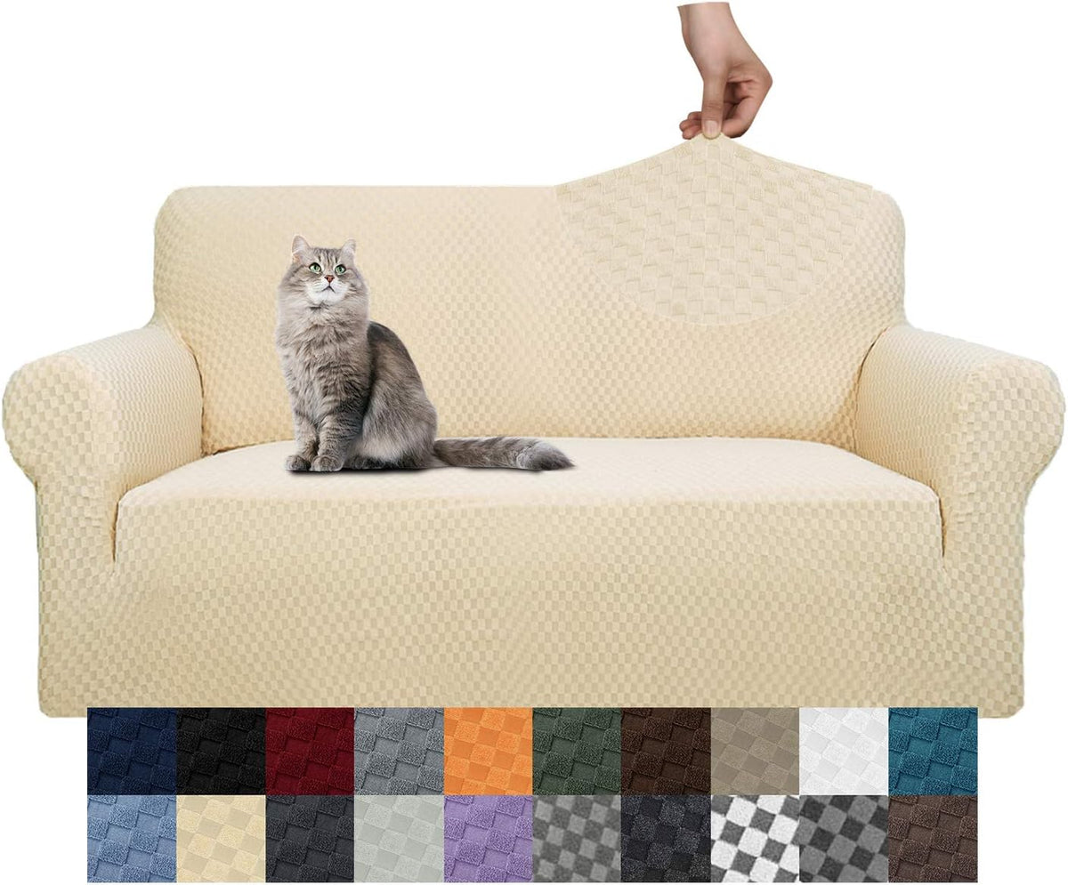 Three-cushion sofa in a cream-colored textured slipcover with a cat on the seat and a hand stretching the fabric.