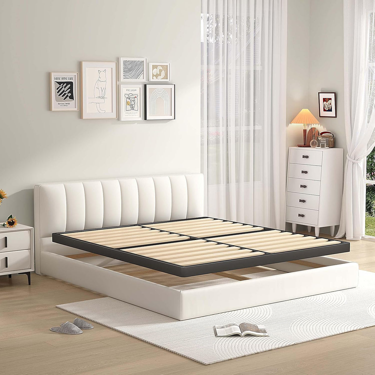 Low-profile metal box spring with wooden slats floating above a white upholstered bed, side perspective
