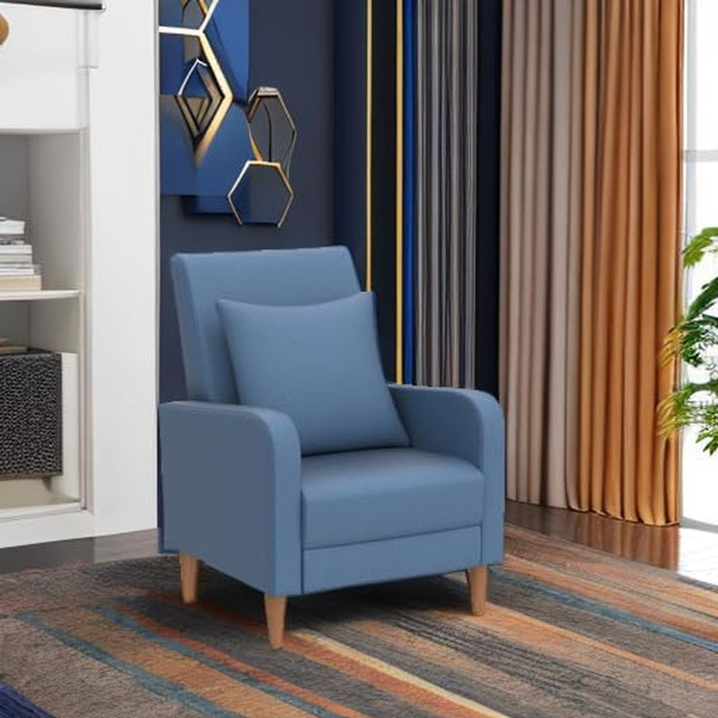 Blue armchair placed on a patterned rug beside curtains and shelving in a styled living room scene.