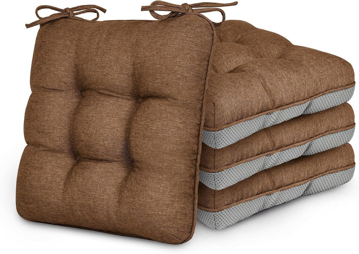 Four stacked tufted square chair cushions in brown showing corner ties and textured fabric