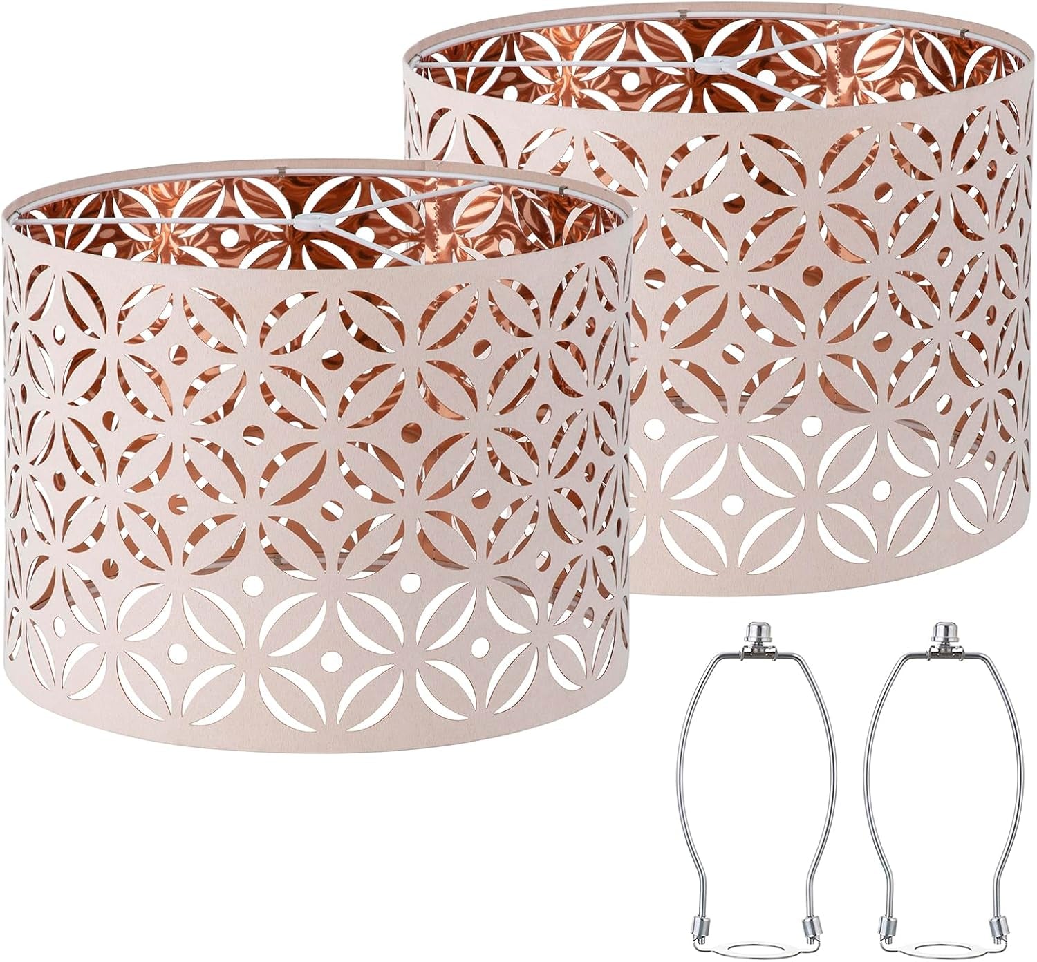 Two rose-gold patterned drum lamp shades with circular cutouts and metallic interior, plus two chrome harp frames.
