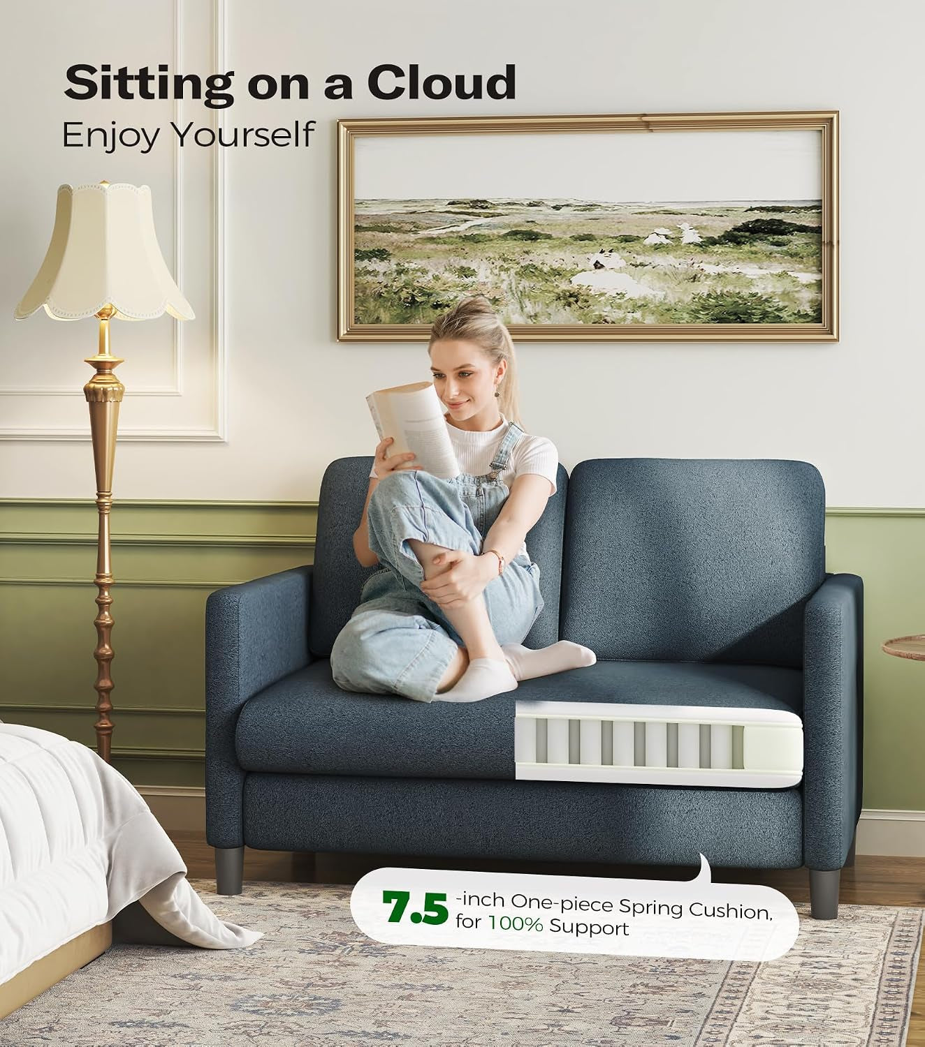 Blue-gray small loveseat in a bedroom setting with a woman reading on it