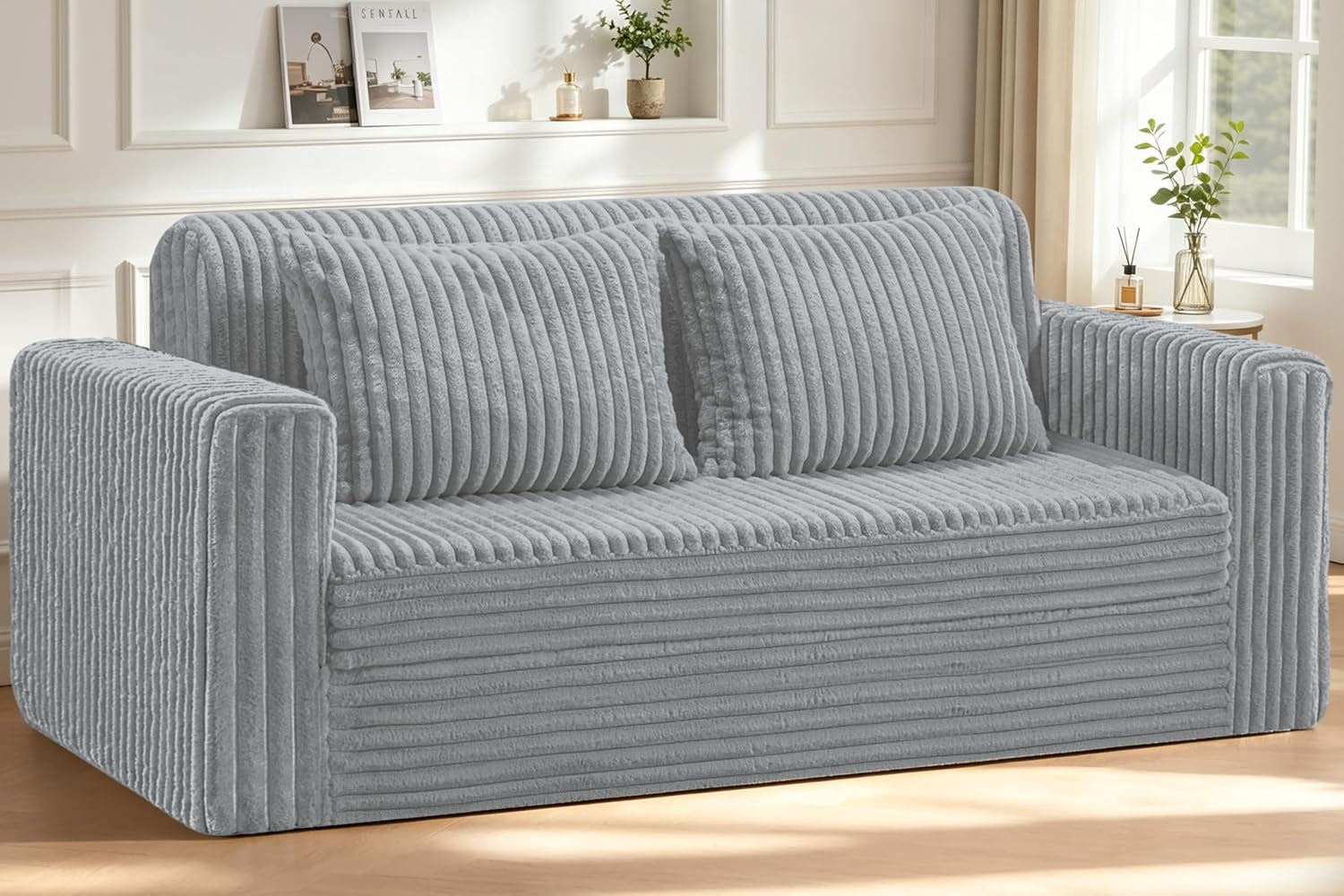 Front view of a light gray ribbed plush loveseat with two matching cushions by a window.