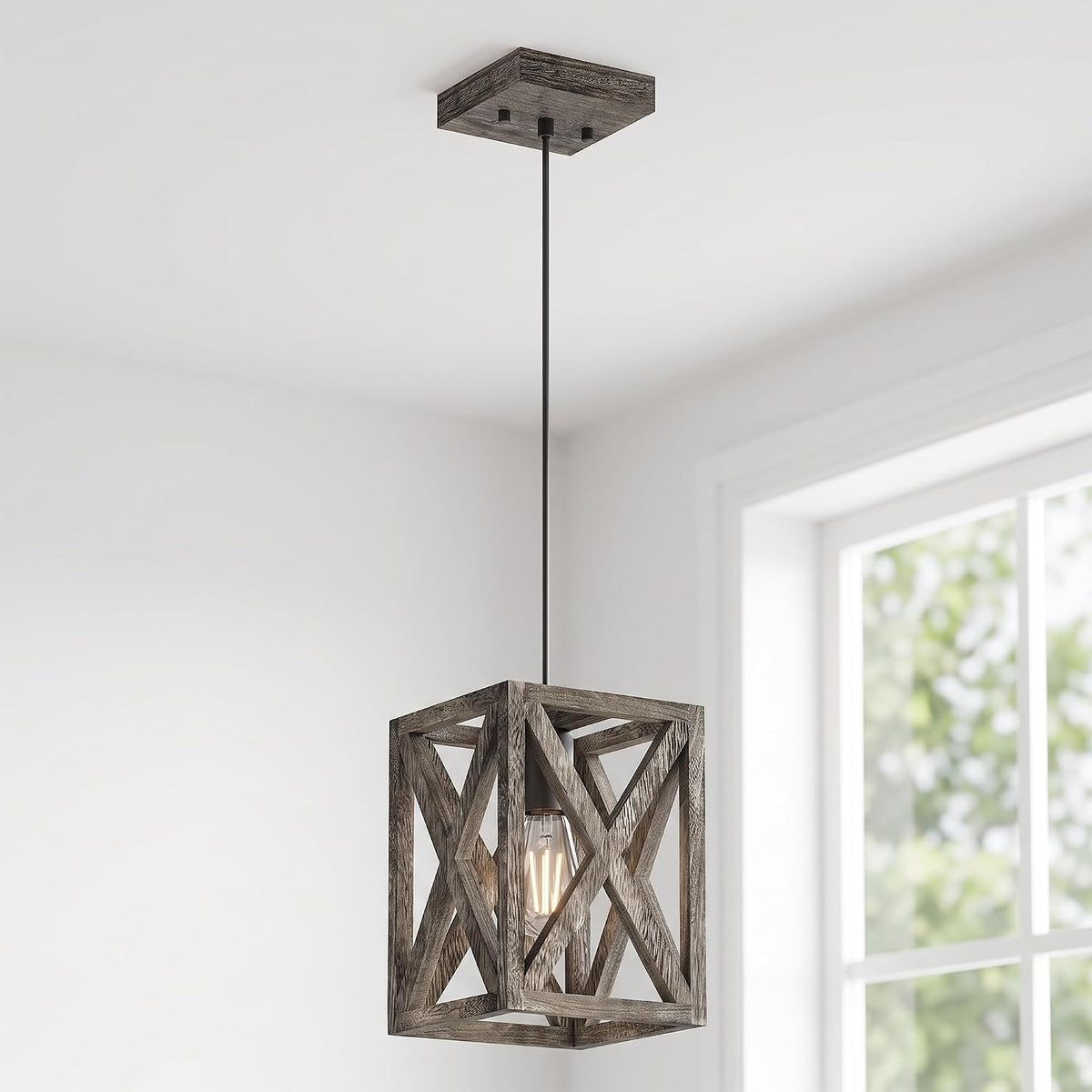 Close-up of a single hanging cube pendant with a wood-look geometric frame and a visible filament bulb.