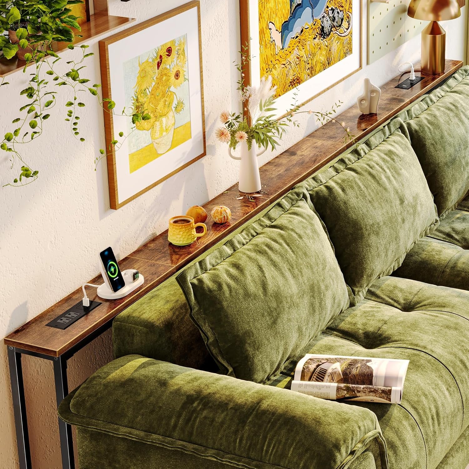 Long narrow console table placed behind a green sectional sofa, showing a rustic wood top and a black power module.