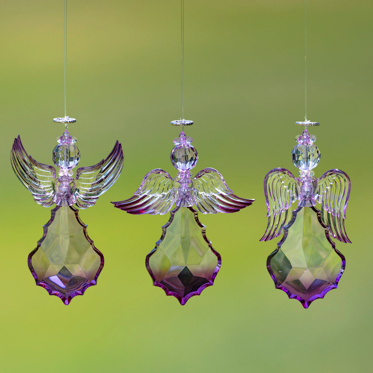 Three hanging purple angel ornaments displayed together, each with a different wing pose.