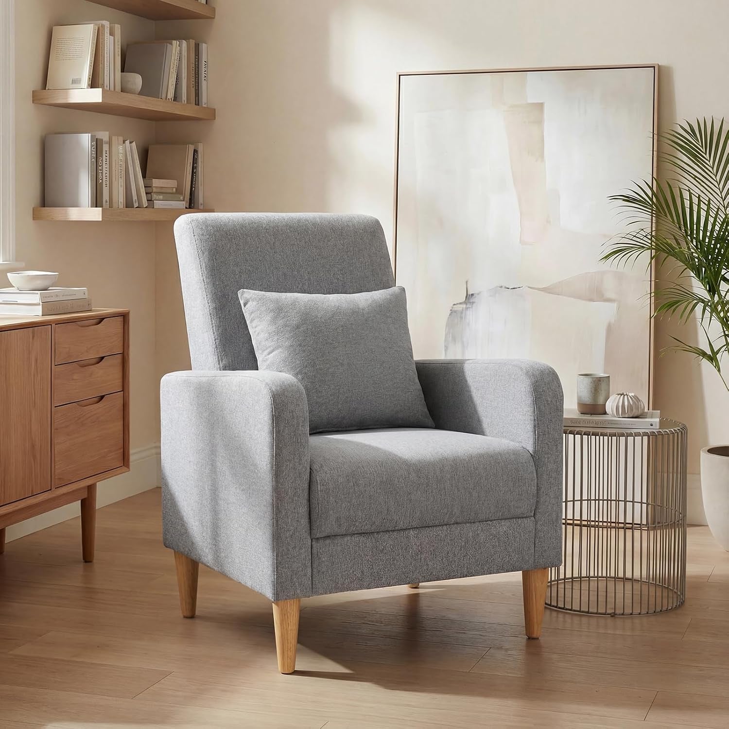 Single gray fabric accent chair with wooden legs in a cozy living room setting