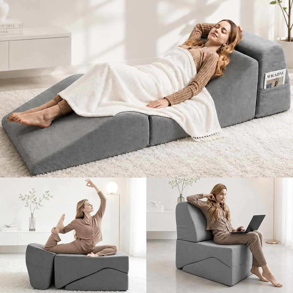 Grey corduroy chaise lounge in reclined full-length position with a person lying under a blanket