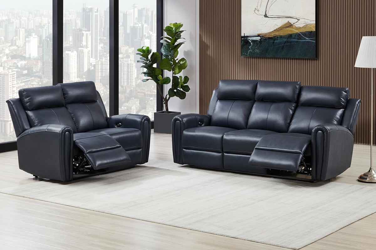 Dark blue leather power reclining sofa and matching loveseat in a bright living room, both footrests partially extended.
