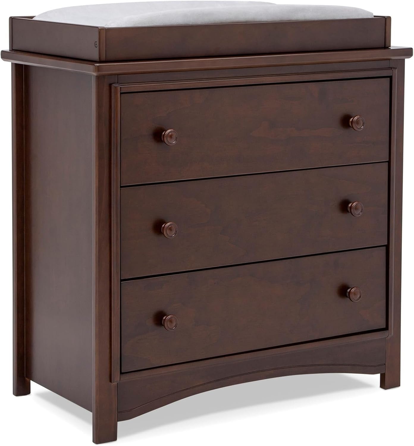 Angled three-quarter view of a dark walnut three-drawer dresser with changing top and round wooden knobs.