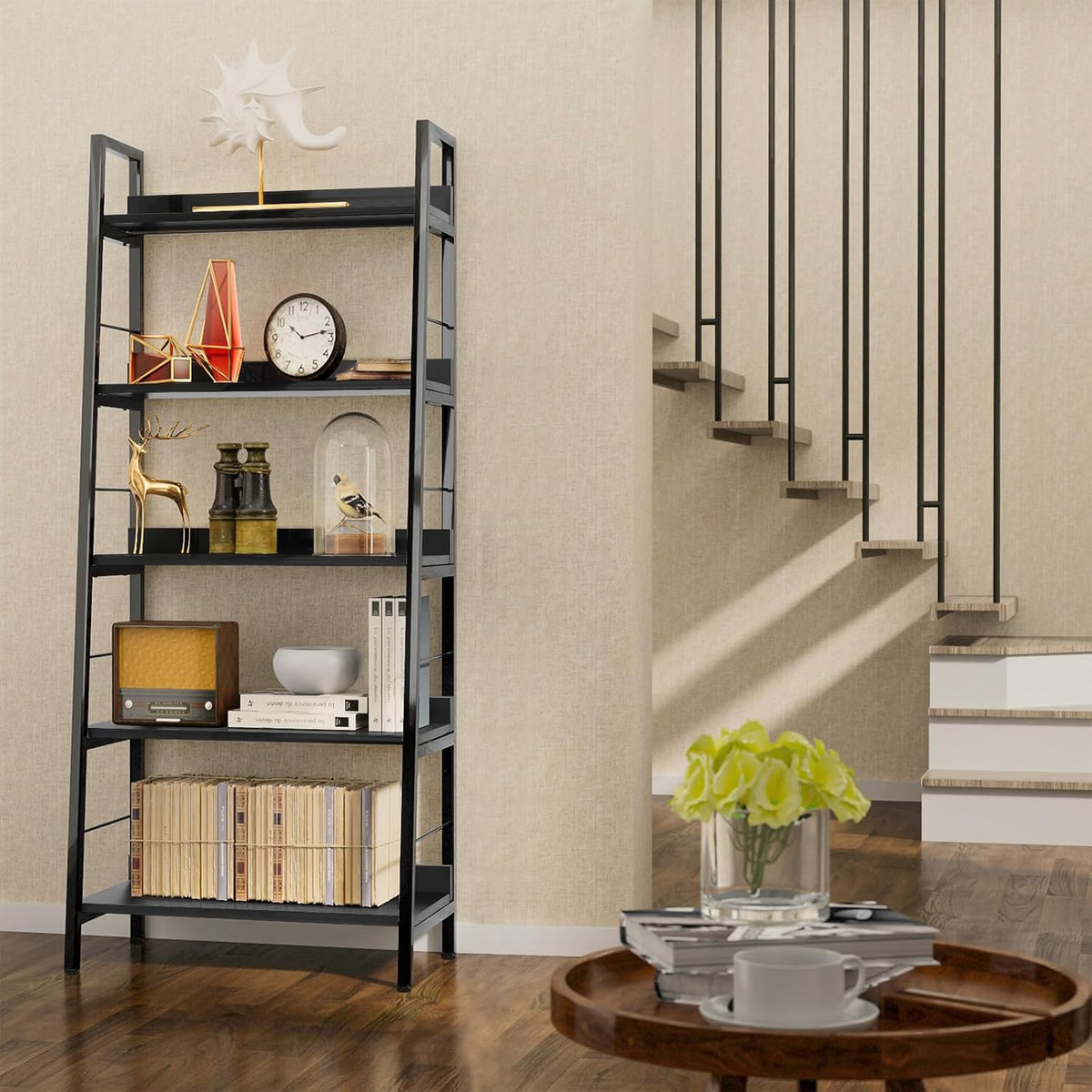 Angled side view of a black ladder bookcase styled with decor next to an open staircase