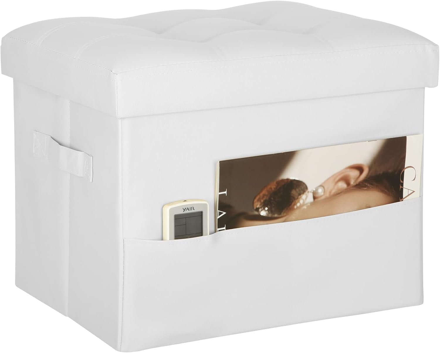 White faux-leather storage ottoman with tufted top and front pocket containing a magazine and a remote.