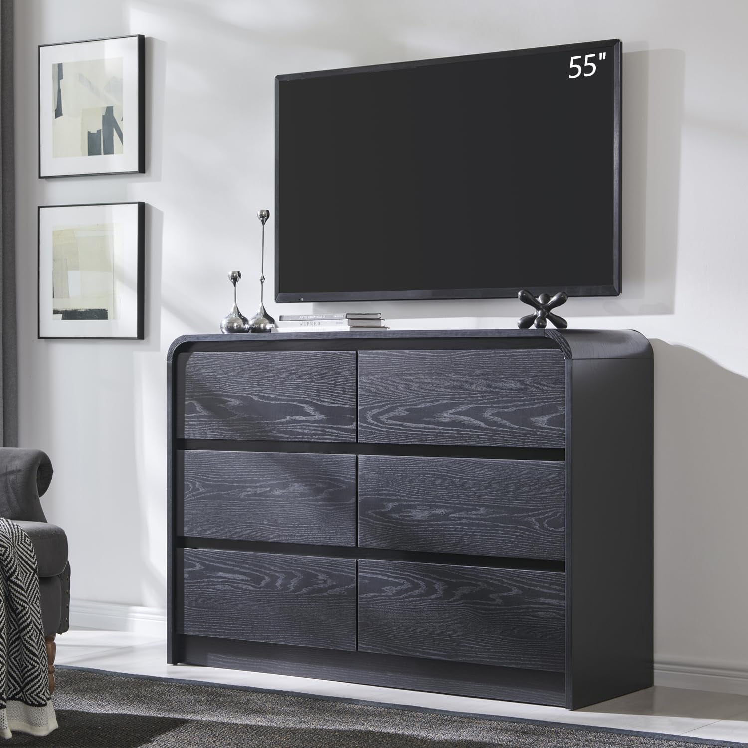Short wide dresser in a charcoal finish used as a media console beneath a mounted TV.