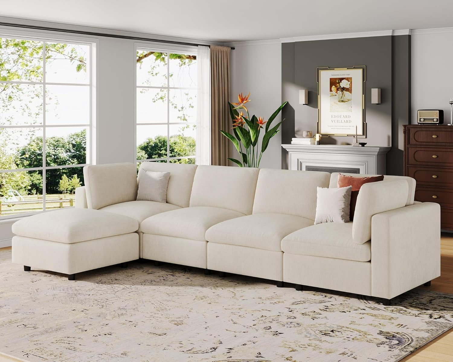 Angled side view of the modular corner sectional in a living room with windows and fireplace in the background.
