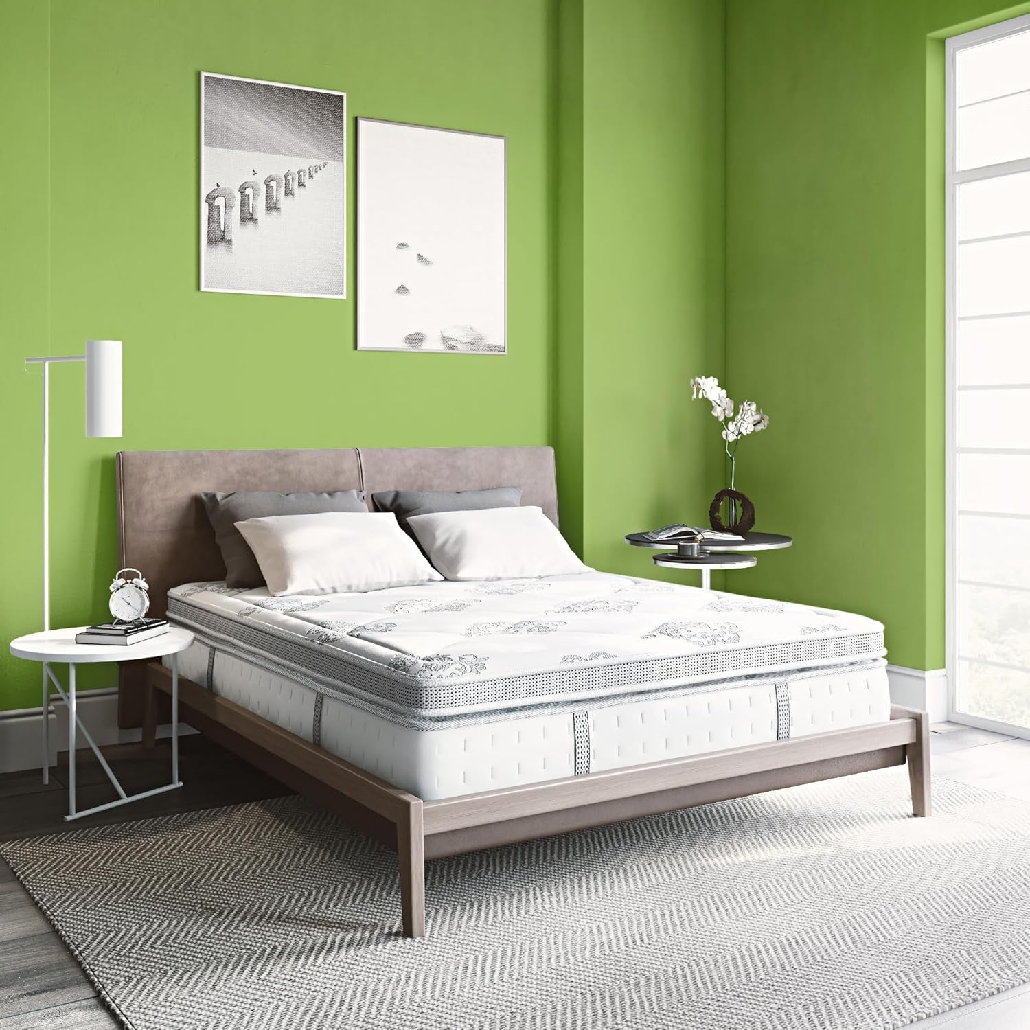 White pillow-top mattress staged on a low wood bed frame against a green bedroom wall