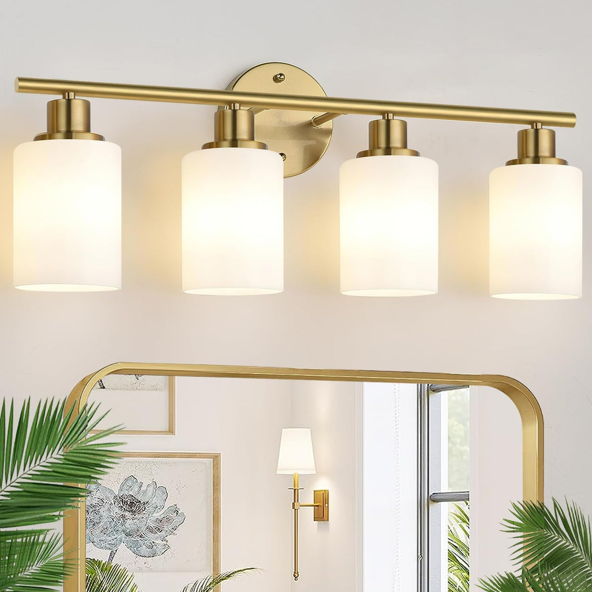 Four-light gold vanity fixture mounted above a mirror in a styled bathroom scene.