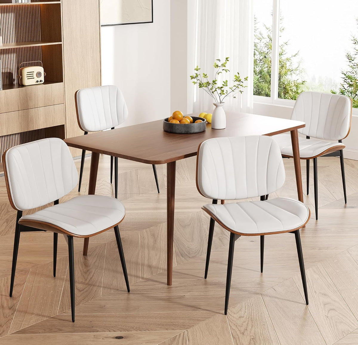 Dining table paired with white faux-leather chairs showing wood-backed profile and black legs.