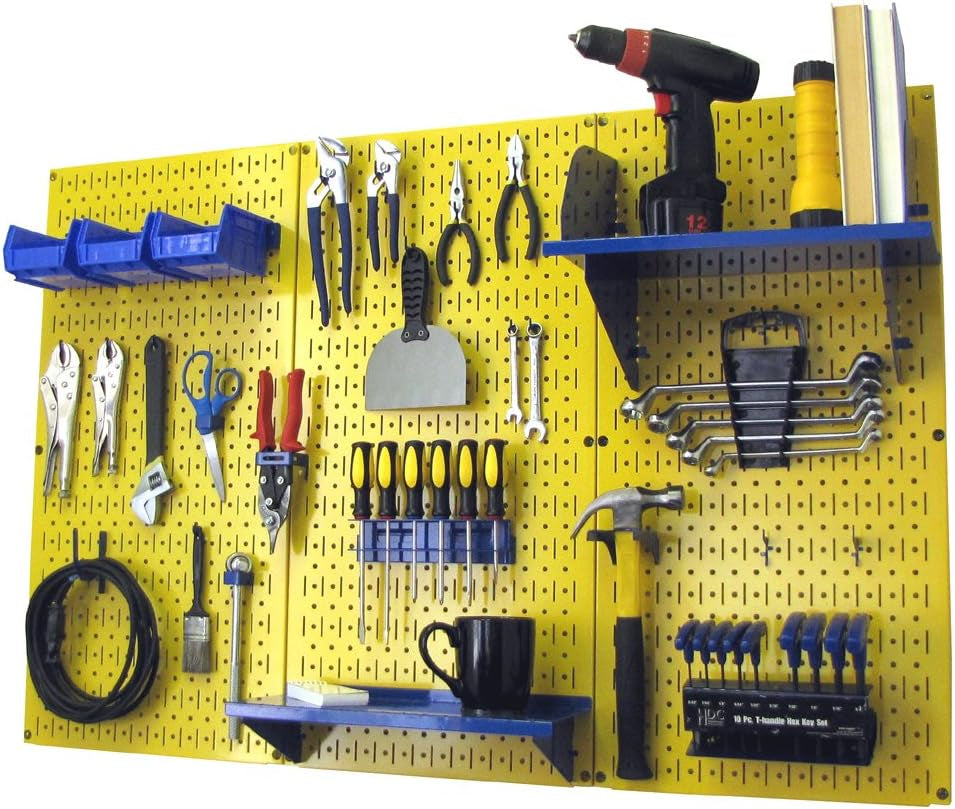 Three yellow pegboard panels with tools, blue shelves and bins, and a coiled cable hung at left.