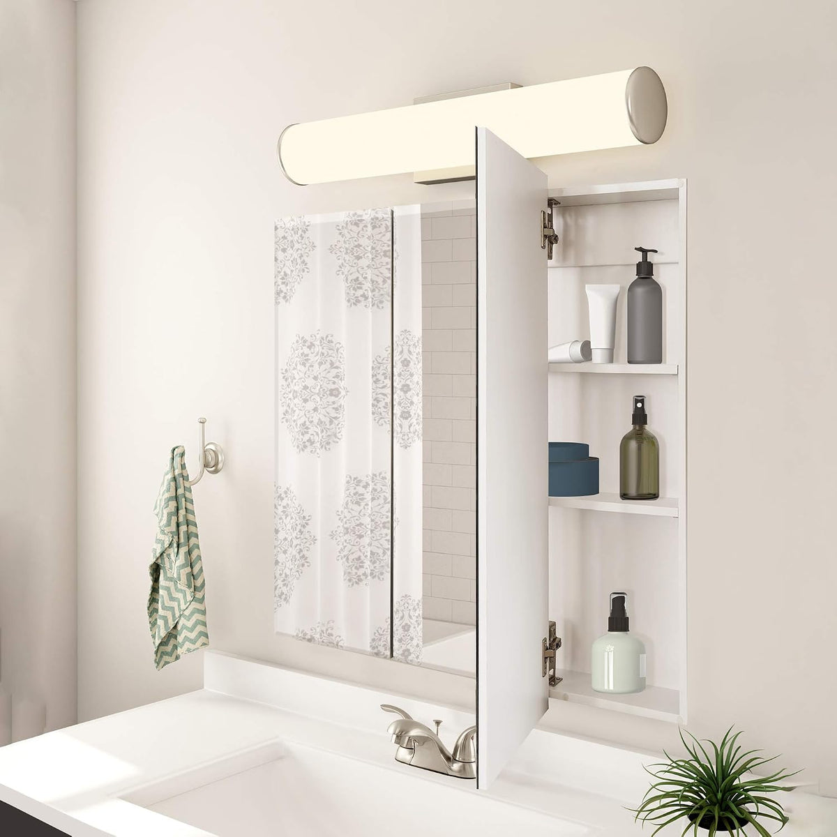 White tri-panel medicine cabinet with right door open above a sink, showing three interior shelves with bottles