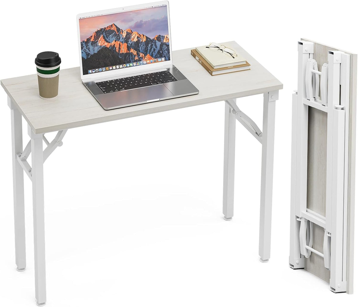 White foldable desk set up with a laptop and a folded desk panel standing beside it