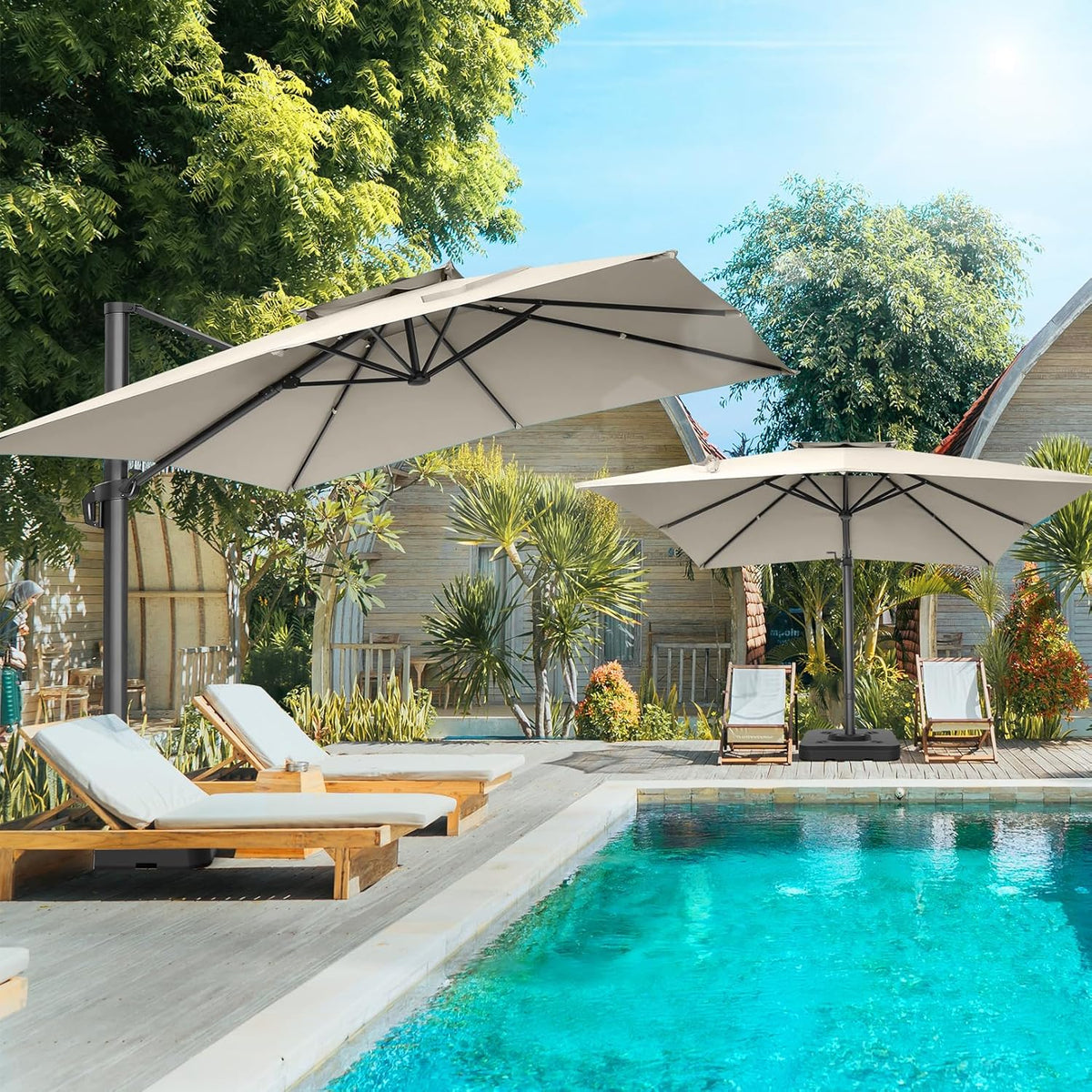 Poolside scene with two offset patio umbrellas shading lounge chairs beside a bright turquoise swimming pool.