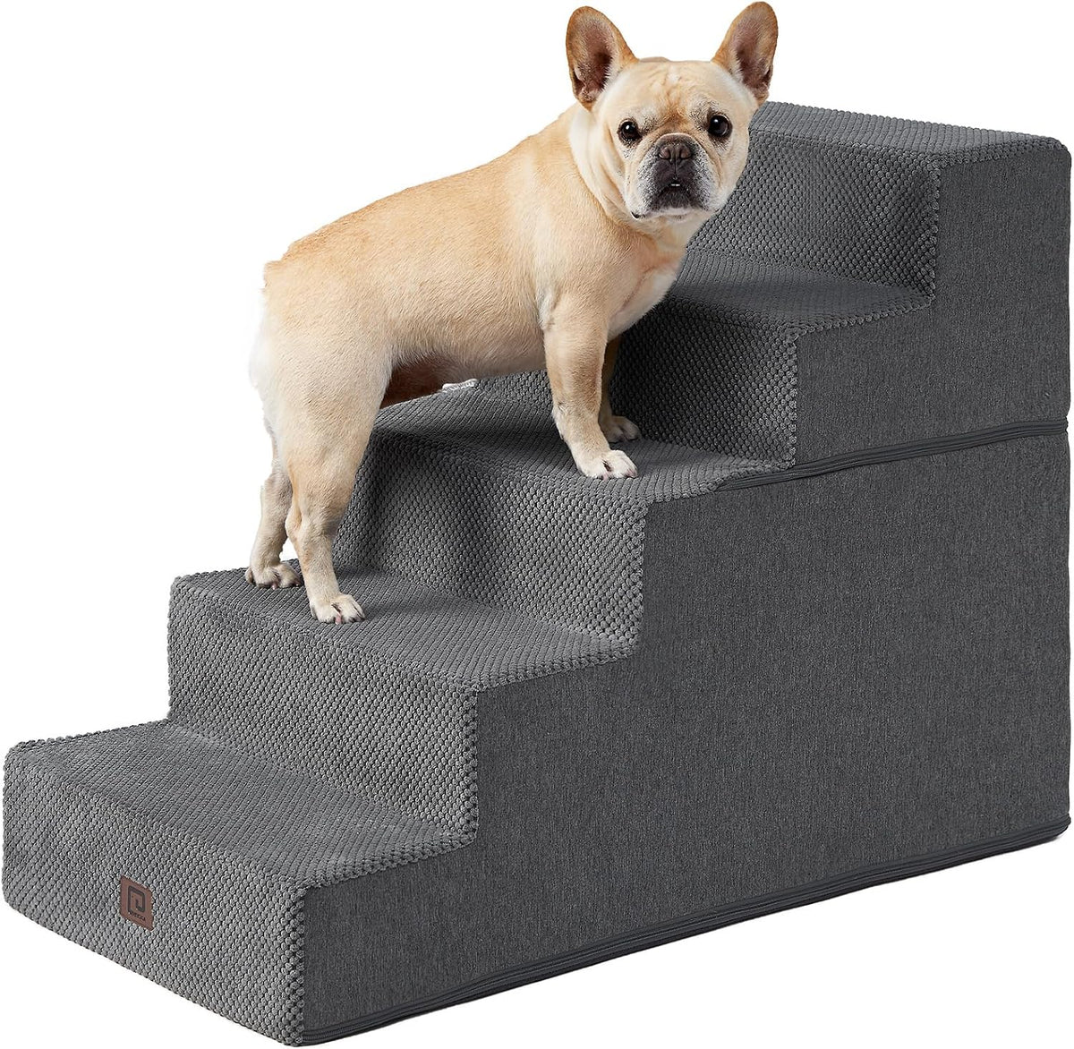 Small tan dog standing on a four-step charcoal gray textured pet stair shown from side