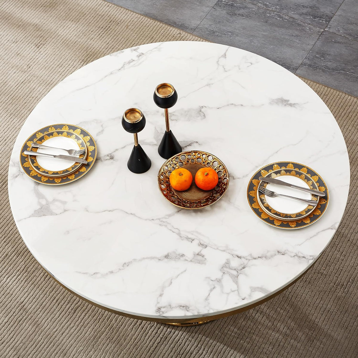 Top-down view of the white faux marble tabletop with place settings and a decorative bowl at center