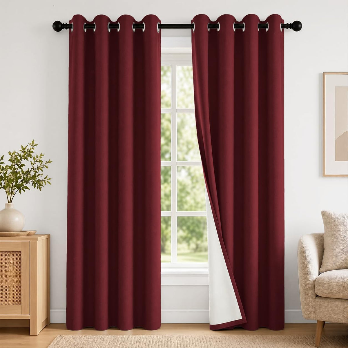 Two burgundy grommet curtains hung over a tall window, right panel slightly opened to show white lining