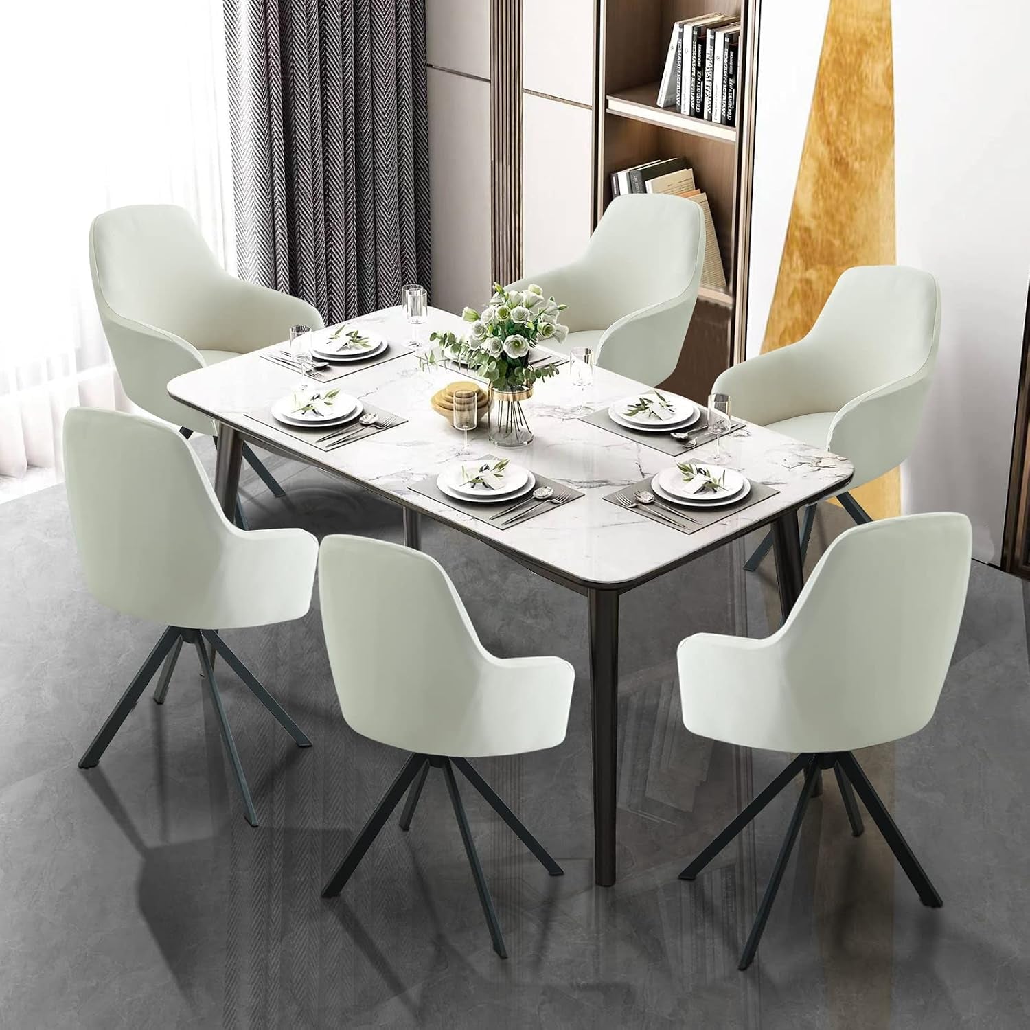 Six mid-back armchairs with pale slipcovers arranged around a dining table set for a meal.