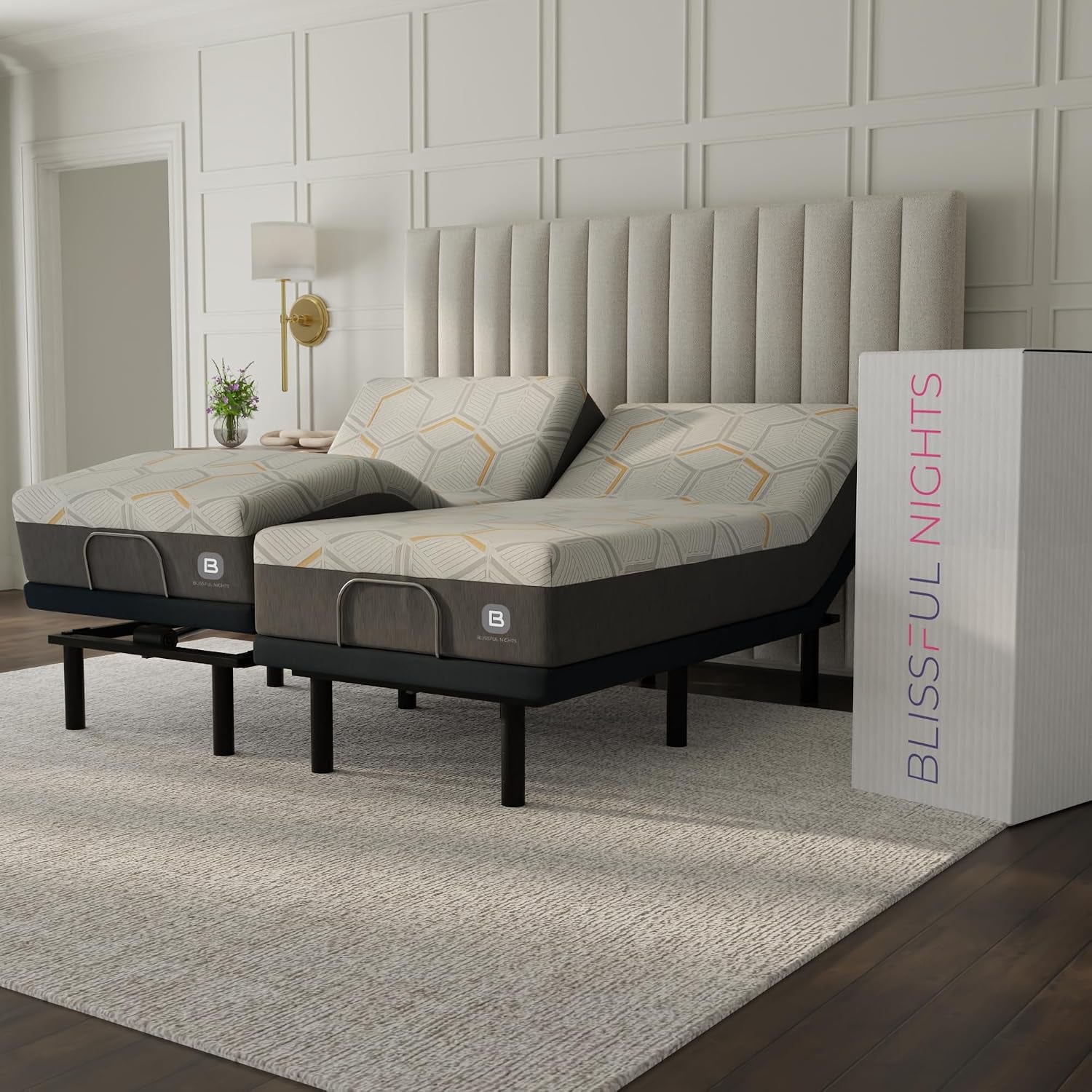 Two mattresses on split adjustable bases next to a tall shipping box at the bed's foot