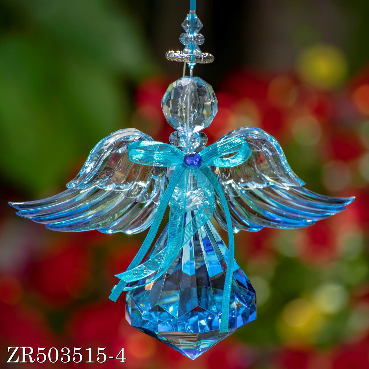 Close product view of a clear-winged angel ornament with a turquoise bow and pointed blue skirt.