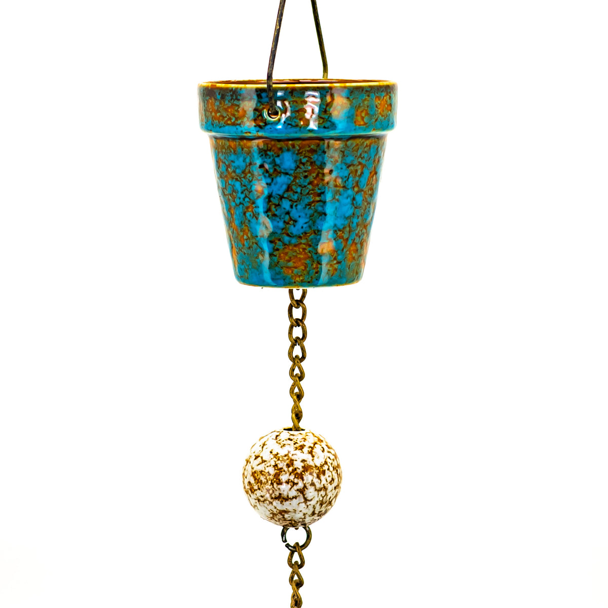 A turquoise and brown glazed bucket rain chain with a hanging chain and round ornament against a white background.