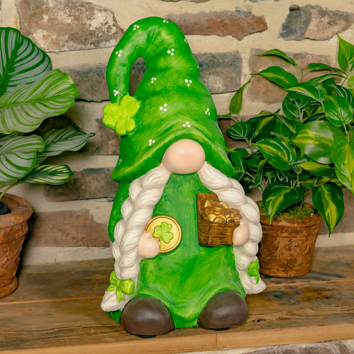Green garden gnome with long white braids holds a gold coin and treasure chest between potted plants.