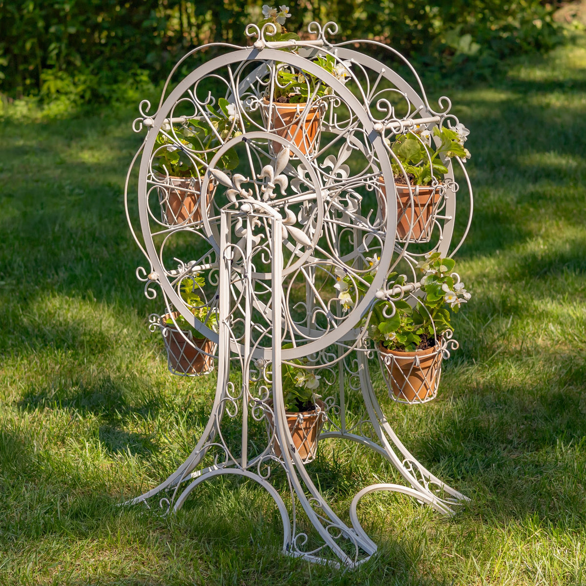 Antique white plant stand with filled baskets viewed from the front