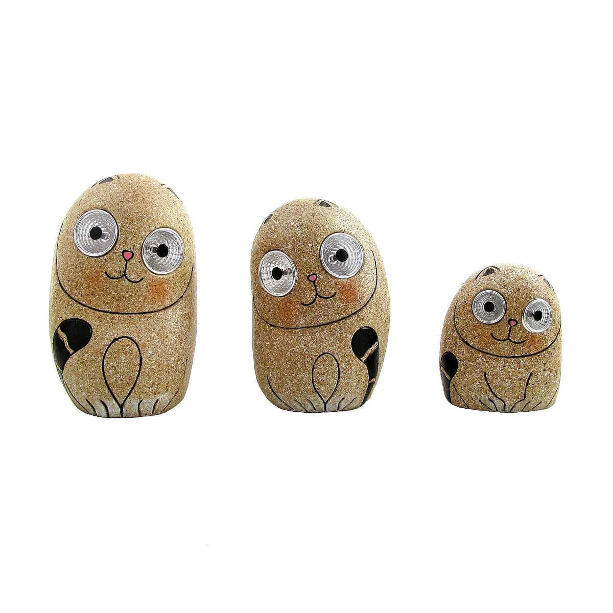 Three taupe, pebble-shaped cat figures with glittery surfaces, painted faces and large round eyes.