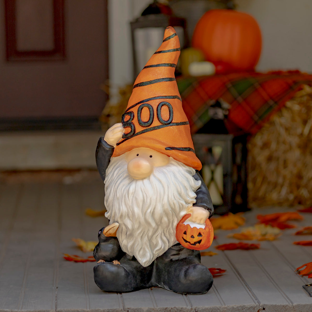 Halloween garden gnome displayed on a porch beside autumn decorations