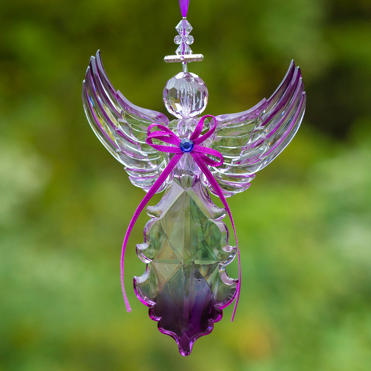 Faceted hanging angel ornament with tall, upward-curving wings, a purple bow, and a deep-purple tint at the base.